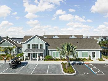 A building with a parking lot in front of it.